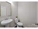 Bright powder room featuring a pedestal sink, framed mirror, and neutral wall paint at 824 Imperial Ct, Charlotte, NC 28273