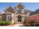 Stunning home with stone and stucco facade, beautiful windows, and lush landscaping at 9901 Strike The Gold Ln, Waxhaw, NC 28173