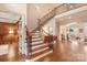The foyer features hardwood floors and a staircase with an iron railing at 9901 Strike The Gold Ln, Waxhaw, NC 28173