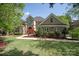 Beautifully landscaped front yard with mature trees and lush green lawn at 9901 Strike The Gold Ln, Waxhaw, NC 28173