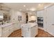Bright kitchen boasts granite countertops, a central island, and stainless steel appliances at 9901 Strike The Gold Ln, Waxhaw, NC 28173