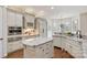 Spacious kitchen boasts custom cabinets, granite countertops, and an inviting breakfast nook with large windows at 9901 Strike The Gold Ln, Waxhaw, NC 28173