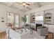 Comfortable living room with a fireplace, custom built-ins, and access to the outdoor patio at 9901 Strike The Gold Ln, Waxhaw, NC 28173