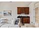 Living room featuring a beverage bar with beautiful wooden cabinets and a mini refrigerator at 9901 Strike The Gold Ln, Waxhaw, NC 28173