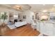 Open-concept living room with coffered ceiling, fireplace, and seamless flow to the kitchen at 9901 Strike The Gold Ln, Waxhaw, NC 28173
