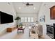 Bright living room features vaulted ceiling, ceiling fan, and entertainment center at 9901 Strike The Gold Ln, Waxhaw, NC 28173