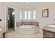 The main bathroom has a tile-surrounded tub with tile flooring and a glass shower at 9901 Strike The Gold Ln, Waxhaw, NC 28173