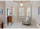 A comfortable chair and large windows provide a place to relax in the main bedroom at 9901 Strike The Gold Ln, Waxhaw, NC 28173