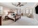 Spacious main bedroom boasts a decorative ceiling, neutral walls, and large windows with plantation shutters at 9901 Strike The Gold Ln, Waxhaw, NC 28173