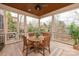 Inviting screened porch featuring wood floors and a cozy dining area overlooking the backyard at 9901 Strike The Gold Ln, Waxhaw, NC 28173
