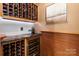 This wine cellar has custom wood shelving and a wine refrigerator with granite countertops at 9901 Strike The Gold Ln, Waxhaw, NC 28173