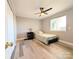 Bedroom with wood-look flooring, ceiling fan, and a window providing natural light at 1056 Latham Ct # B104, Rock Hill, SC 29732