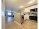 Open kitchen with white cabinets and stainless steel appliances overlooking the living area at 1056 Latham Ct # B104, Rock Hill, SC 29732