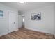 Spacious bedroom features wood-look floors, neutral paint, and a view to another room at 116 Garrison Dr, Belmont, NC 28012