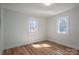 Inviting bedroom with wood-look floors and lots of natural light from its two windows at 116 Garrison Dr, Belmont, NC 28012