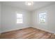 Comfortable bedroom with wood-look flooring and natural light streaming through two windows at 116 Garrison Dr, Belmont, NC 28012