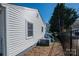 Charming home exterior showcases siding, a fenced yard, and an efficient air conditioning unit at 116 Garrison Dr, Belmont, NC 28012