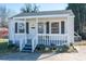 Charming single-story home with a covered front porch, gray shutters, and landscaped yard at 116 Garrison Dr, Belmont, NC 28012