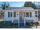 Charming single-story home with a covered front porch, gray shutters, and landscaped yard at 116 Garrison Dr, Belmont, NC 28012