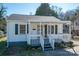 Charming single-story home with a covered front porch, gray shutters, and landscaped yard at 116 Garrison Dr, Belmont, NC 28012