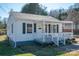 Charming single-story home with a covered front porch, gray shutters, and landscaped yard at 116 Garrison Dr, Belmont, NC 28012