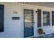 Inviting front porch with decorative mailbox, accent lighting, and decorative gray shutters at 116 Garrison Dr, Belmont, NC 28012