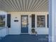 Charming porch with a blue deck, clean white railings, stylish black shutters, and a quaint front door at 116 Garrison Dr, Belmont, NC 28012