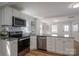 Well-appointed kitchen featuring white cabinets, stainless steel appliances, and an open layout at 116 Garrison Dr, Belmont, NC 28012