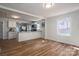 Bright, open-concept living room features hardwood floors, a well-lit kitchen and a view of the interior at 116 Garrison Dr, Belmont, NC 28012