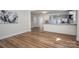 Open-concept living room with beautiful hardwood floors and a view of the adjacent kitchen and dining area at 116 Garrison Dr, Belmont, NC 28012