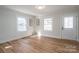 Bright living room featuring hardwood floors, natural light, and a charming front door at 116 Garrison Dr, Belmont, NC 28012