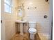 Bathroom with white tile, pedestal sink, and natural light at 121 Ne 33Rd Ave, Hickory, NC 28601