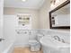 Bright bathroom with a pedestal sink and a window bringing in natural light at 121 Ne 33Rd Ave, Hickory, NC 28601