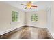 Bedroom featuring hardwood flooring, multiple windows, and natural light at 121 Ne 33Rd Ave, Hickory, NC 28601