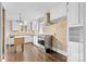 A well-lit kitchen featuring white cabinets, tiled walls, hardwood floors, and stainless steel appliances at 121 Ne 33Rd Ave, Hickory, NC 28601