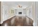Open living room with hardwood floors, a brick fireplace with built-in shelves, and a bright and airy ambiance at 121 Ne 33Rd Ave, Hickory, NC 28601