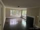 Well-lit living room with hardwood floors, a cozy fireplace, and view through the many windows at 121 Ne 33Rd Ave, Hickory, NC 28601