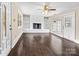 Bright living room featuring a white brick fireplace, hardwood floors, and large windows at 121 Ne 33Rd Ave, Hickory, NC 28601