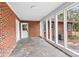 Enclosed brick sunroom featuring tiling, bright light and access to the backyard at 121 Ne 33Rd Ave, Hickory, NC 28601