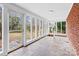 Relaxing sunroom with stone floors and floor-to-ceiling windows overlooking backyard at 121 Ne 33Rd Ave, Hickory, NC 28601