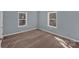 Bedroom with gray walls, two windows, and wood-look floors at 1229 Jenkins St, Rock Hill, SC 29732