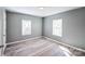Bedroom with gray walls, wood-look floors, and two windows at 1229 Jenkins St, Rock Hill, SC 29732
