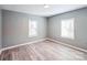 Bedroom with gray walls, wood-look floors, and two windows at 1229 Jenkins St, Rock Hill, SC 29732