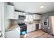 Bright kitchen featuring white cabinets, stainless steel appliances, and new floors at 1229 Jenkins St, Rock Hill, SC 29732
