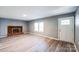 Open-concept living area featuring a brick fireplace, and new wood flooring at 1229 Jenkins St, Rock Hill, SC 29732