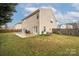 Expansive backyard featuring a concrete patio, lush lawn, and wooden fence, perfect for outdoor living at 128 Lacona Trce, Mooresville, NC 28115