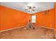 Bright orange room with carpet, a ceiling fan, and a teepee as a fun decorative accent at 128 Lacona Trce, Mooresville, NC 28115