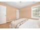 A cozy bedroom with carpet, a bright window, and a comfortable bed for relaxation at 128 Lacona Trce, Mooresville, NC 28115
