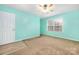 Empty bedroom with seafoam walls, carpet, and natural light from a window at 128 Lacona Trce, Mooresville, NC 28115
