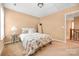Inviting bedroom with soft carpet, neutral walls, complemented by a plush, patterned comforter at 128 Lacona Trce, Mooresville, NC 28115
